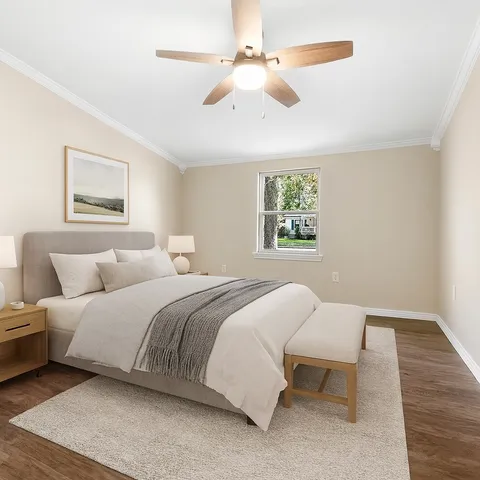 a bedroom with a bed and a chandelier