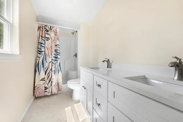 a bathroom with a sink a toilet and a shower