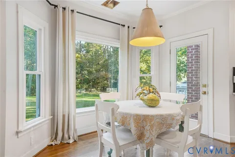 a dining room with a window and chairs