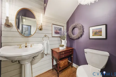 a bathroom with a toilet a sink and a mirror