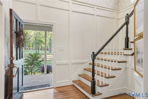 a view of entryway with wooden floor and front door