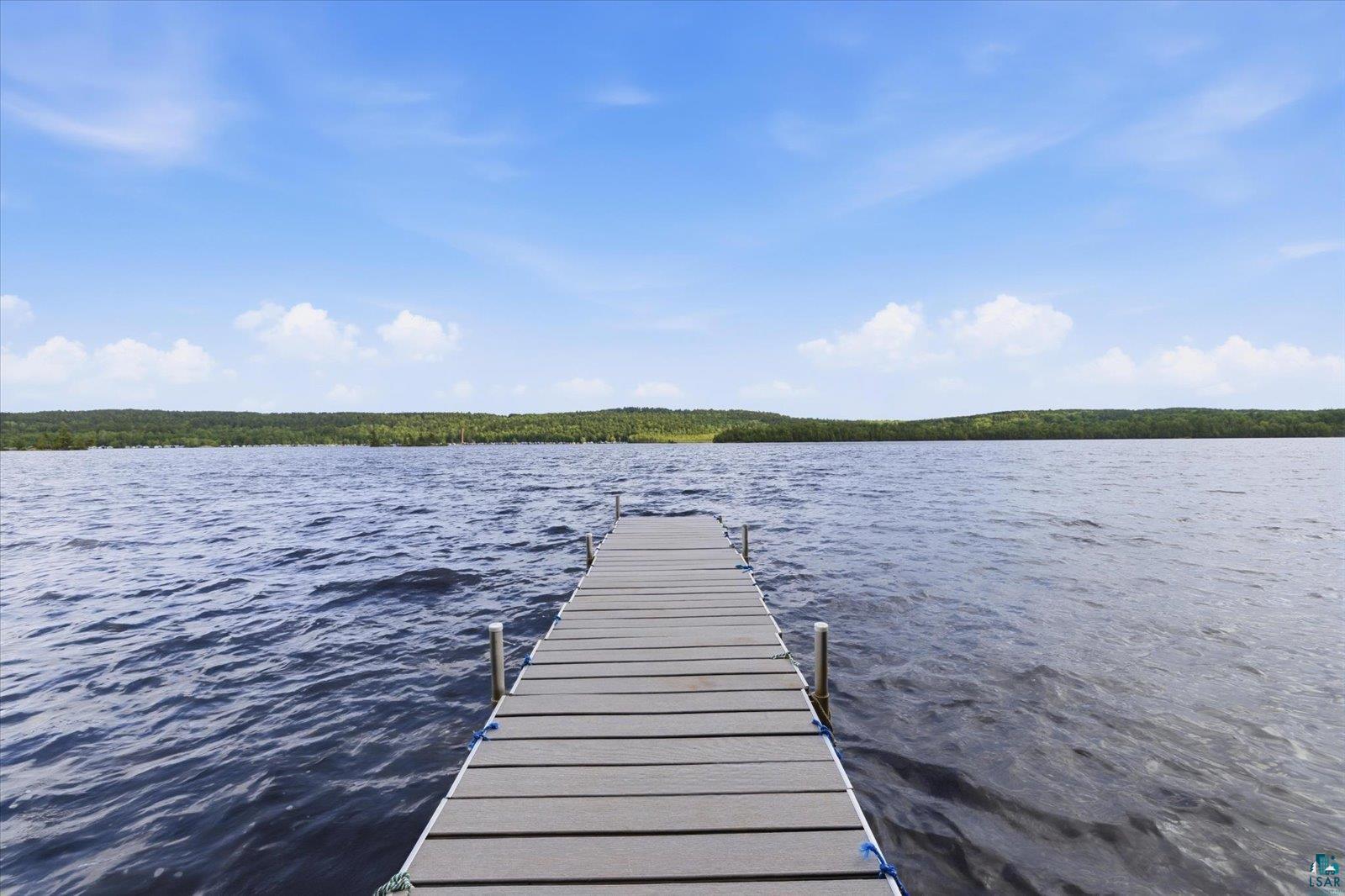 5298 Long Island Tower, MN 55790 - Photo 3 of 31 Private dock extending into open water, featuring a clear sky and distant tree line