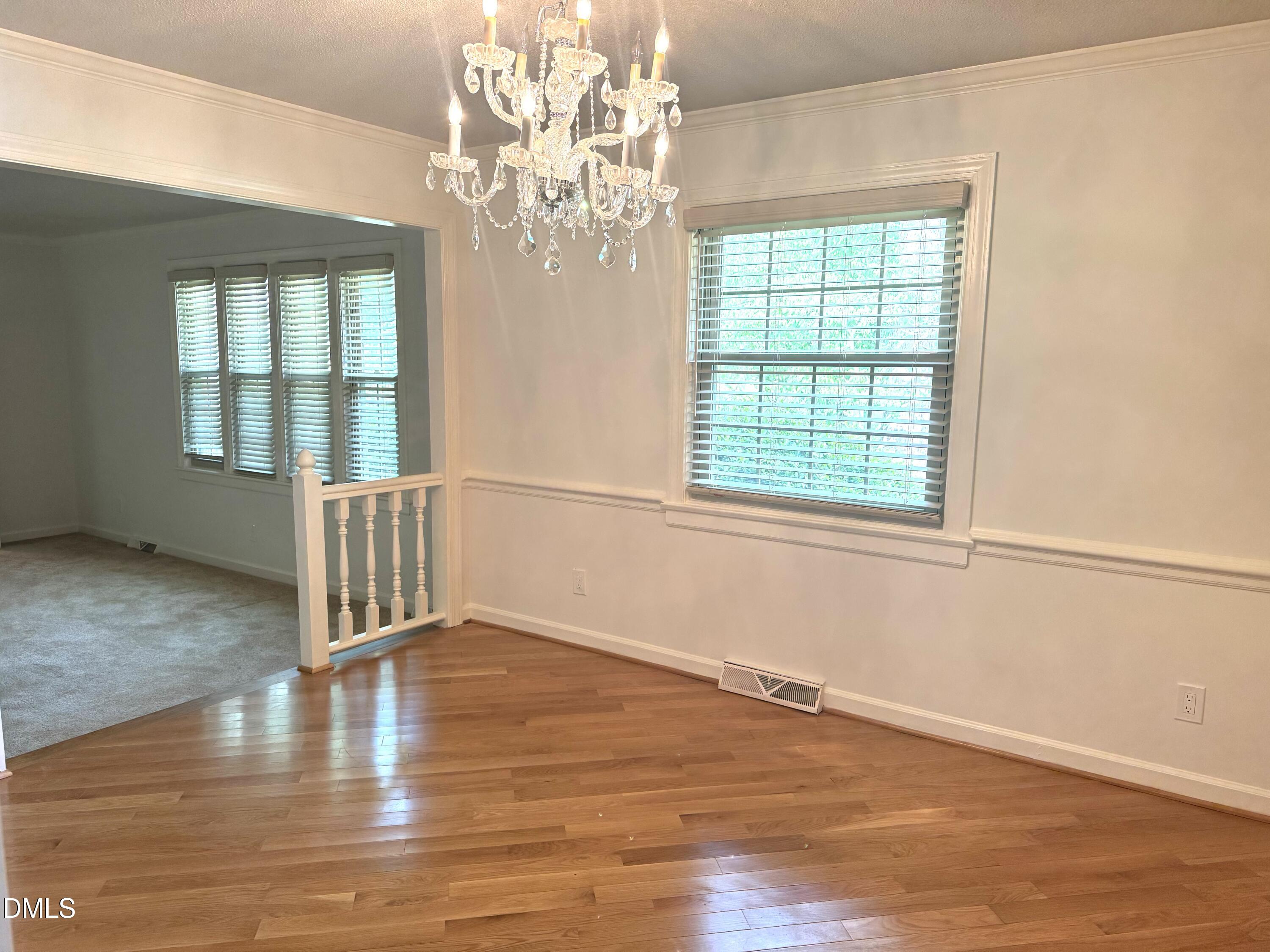 8133 Holly Forest Road Wake Forest, NC 27587 - Photo 22 of 50 a view of an empty room with wooden floor and a window