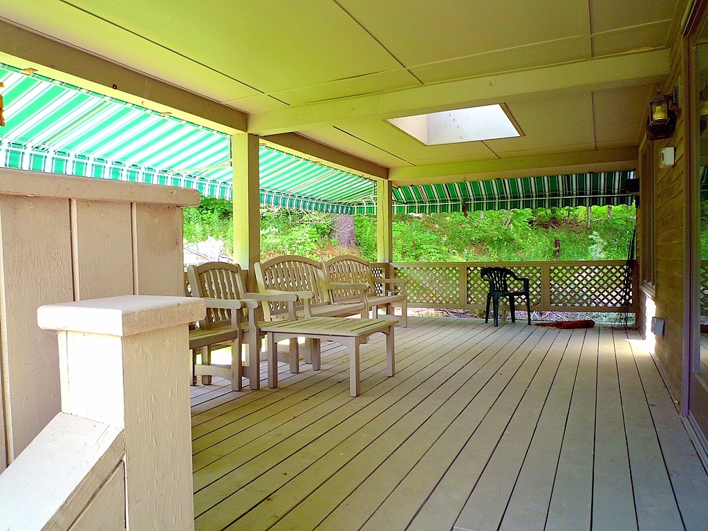 316 Hancock Road Williamstown, MA 01267 - Photo 5 of 21 a view of a patio with table and chairs wooden floor and fence