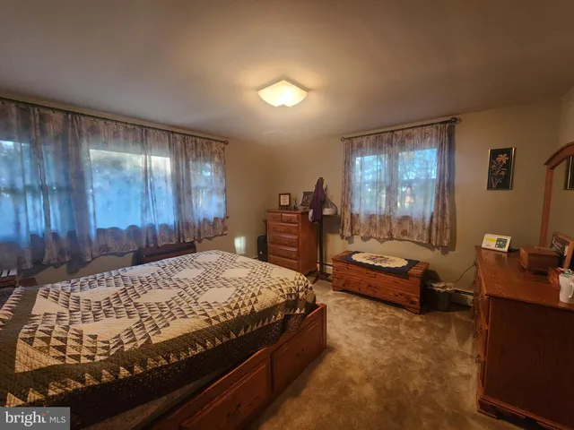 a bedroom with a bed and dresser