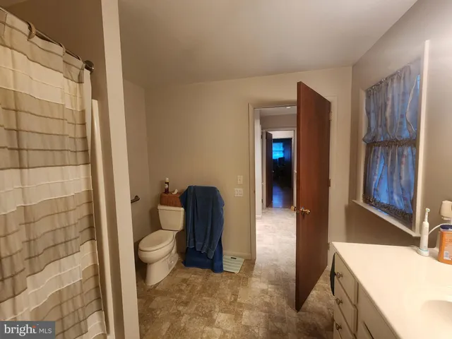 a bathroom with a tub and toilet