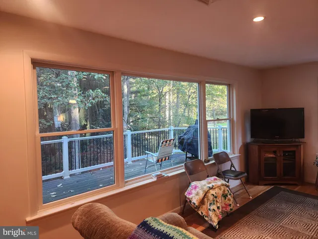 a bedroom with furniture and a flat screen tv