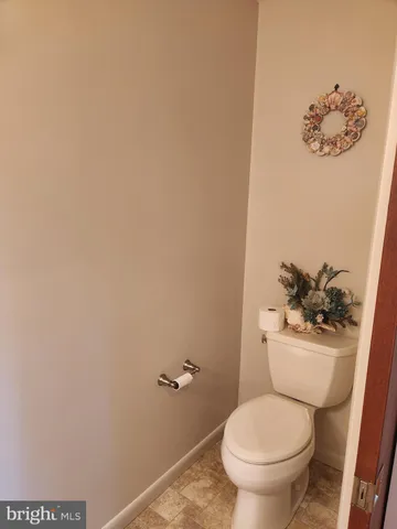 a white toilet sitting next to a sink