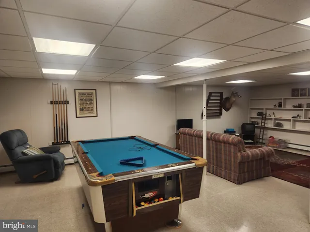 a living room with furniture a rug and a window