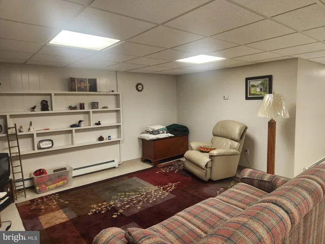 a bedroom with furniture and a wooden floor