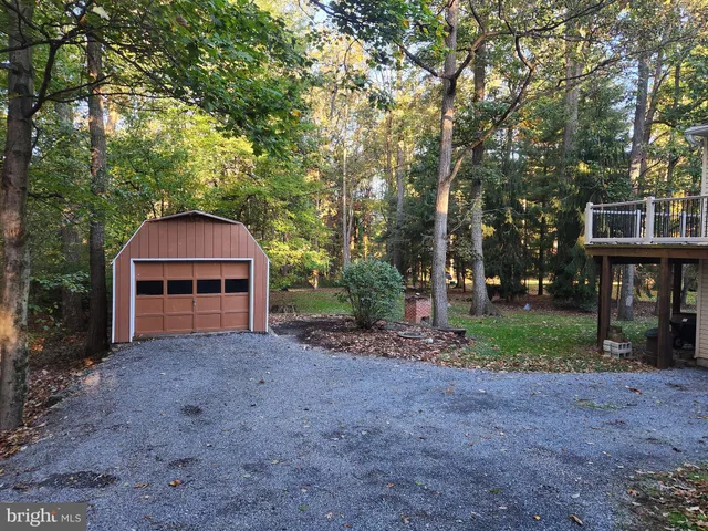 a view of house with outdoor space and trees