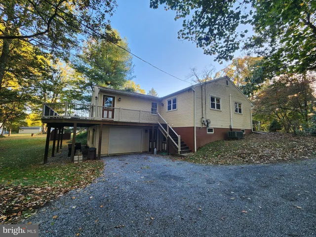 a view of a house with a yard and sitting area