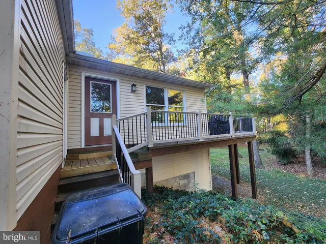 a view of a house with backyard and deck