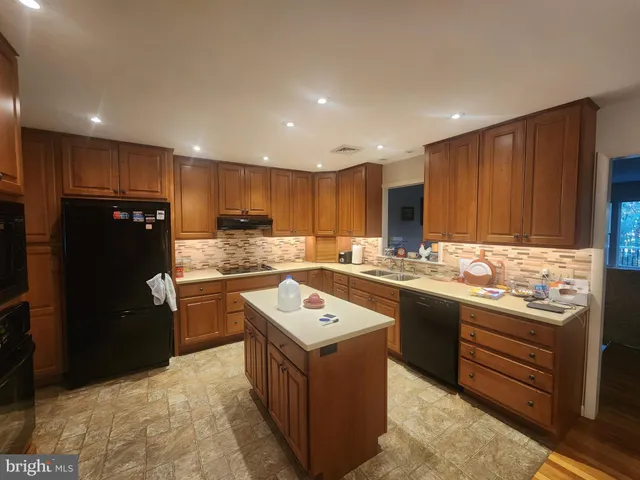 a kitchen with a sink stove and refrigerator