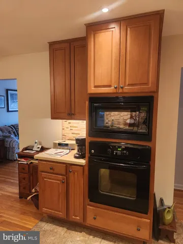 a kitchen with granite countertop a stove top oven