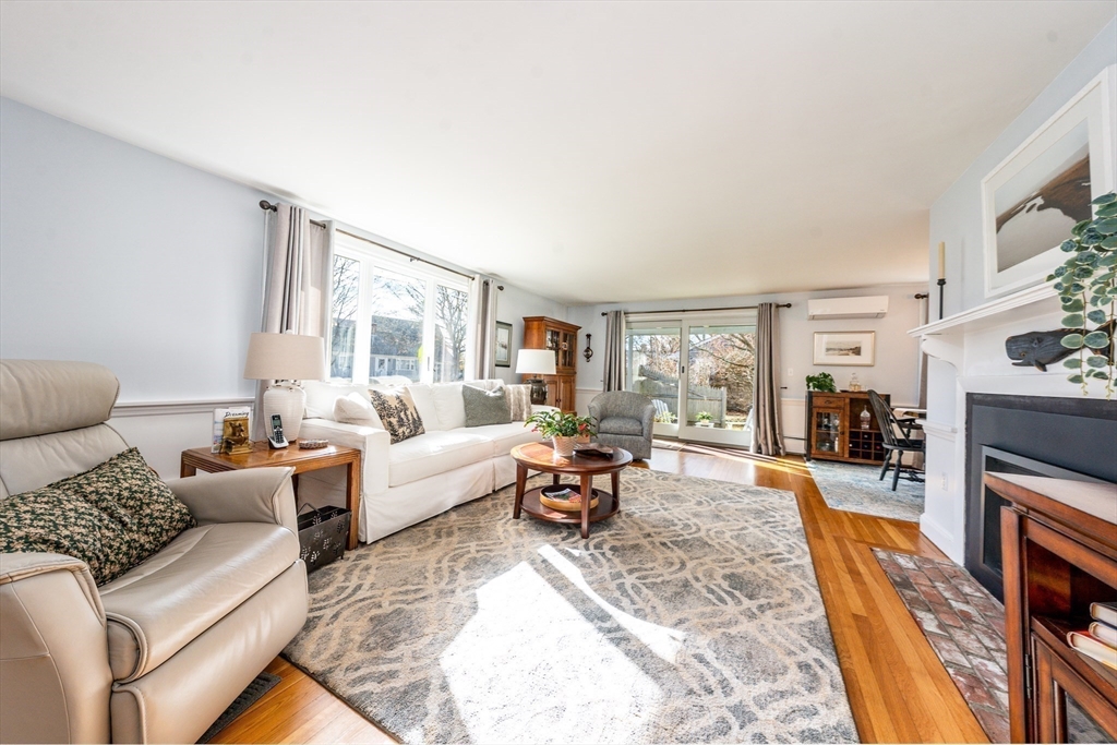 142 Chestnut Street Barnstable, MA 02601 - Photo 17 of 42 a living room with furniture large window and a fireplace