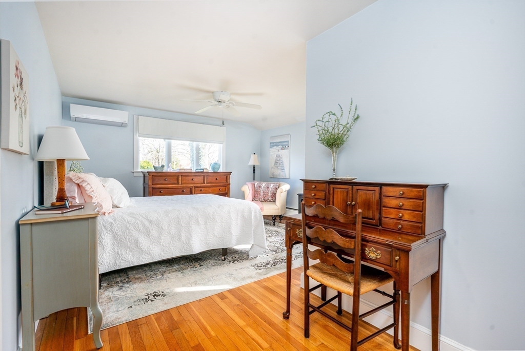 142 Chestnut Street Barnstable, MA 02601 - Photo 19 of 42 a bedroom with a bed and a table in it