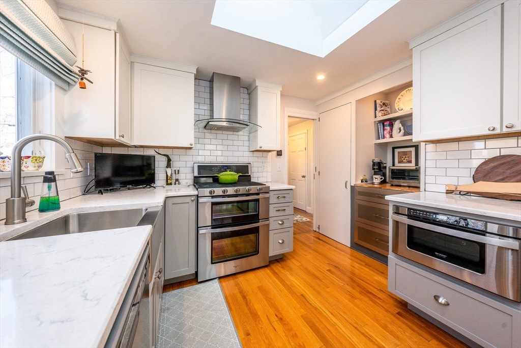 142 Chestnut Street Barnstable, MA 02601 - Photo 2 of 42 a kitchen with stainless steel appliances granite countertop a stove top oven a sink a counter space and cabinets