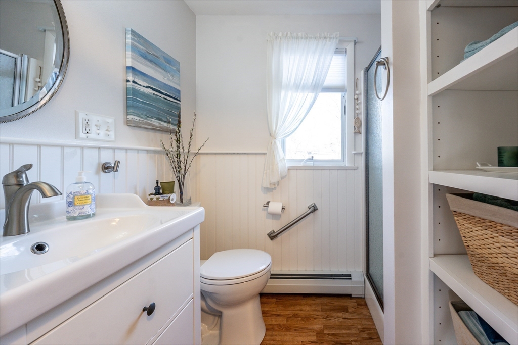142 Chestnut Street Barnstable, MA 02601 - Photo 29 of 42 a bathroom with a sink a toilet and a mirror