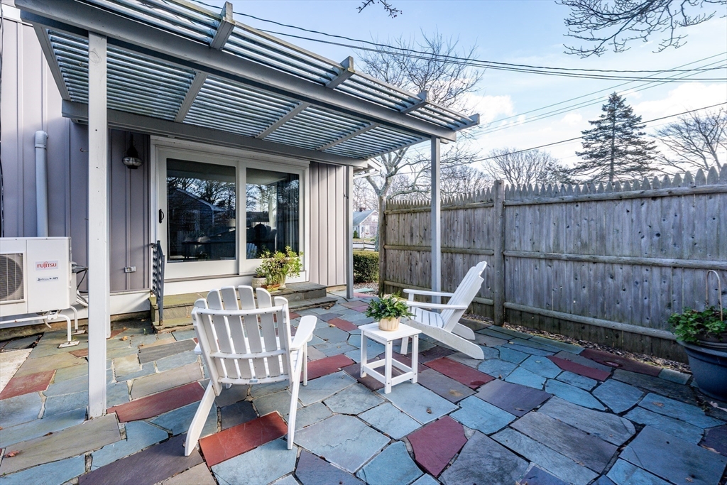 142 Chestnut Street Barnstable, MA 02601 - Photo 30 of 42 a view of a patio with table and chairs potted plants with wooden floor