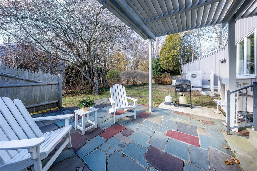 142 Chestnut Street Barnstable, MA 02601 - Photo 31 of 42 a view of backyard with seating space and trees