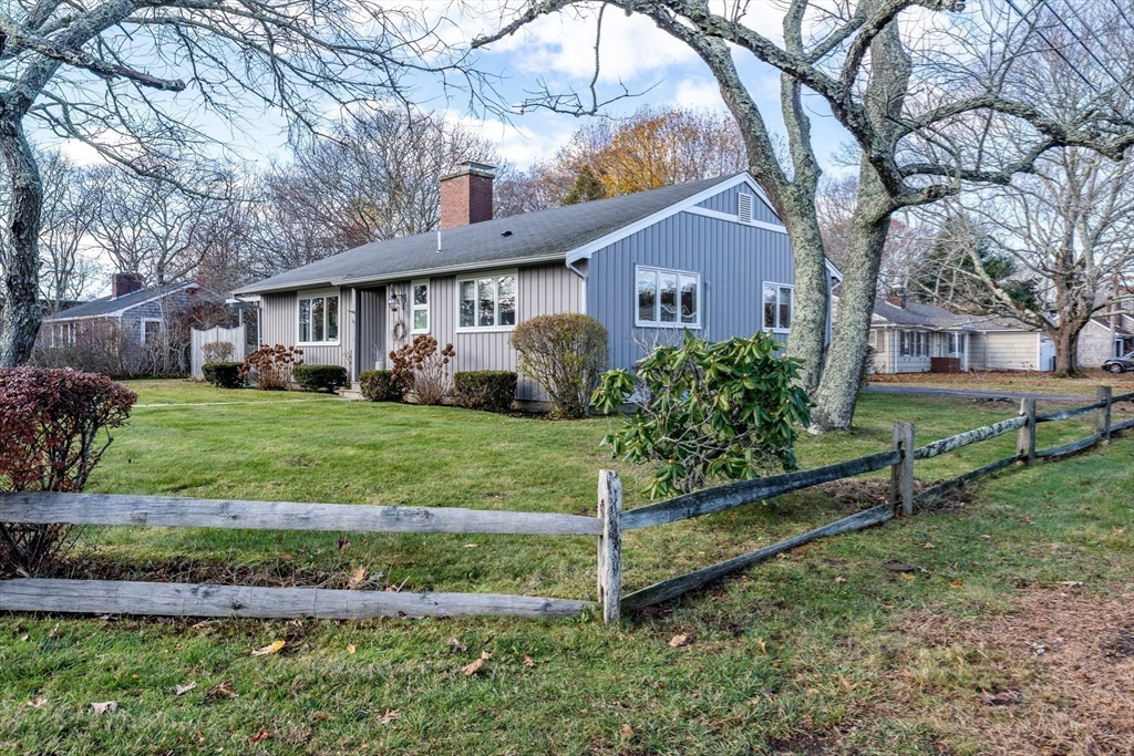 142 Chestnut Street Barnstable, MA 02601 - Photo 38 of 42 a view of a house with a yard and large trees