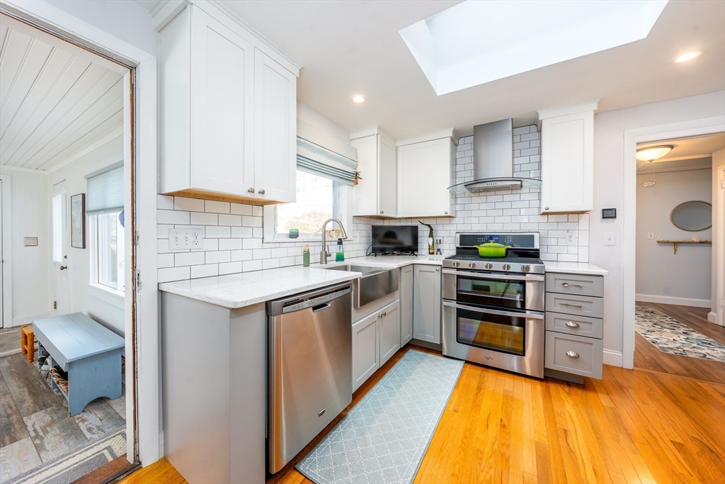 142 Chestnut Street Barnstable, MA 02601 - Photo 7 of 42 a kitchen with stainless steel appliances a stove sink and cabinets