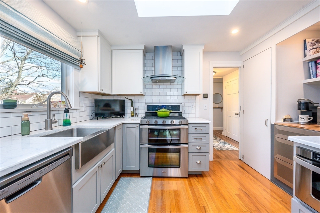142 Chestnut Street Barnstable, MA 02601 - Photo 8 of 42 a kitchen with stainless steel appliances a stove a sink and a refrigerator