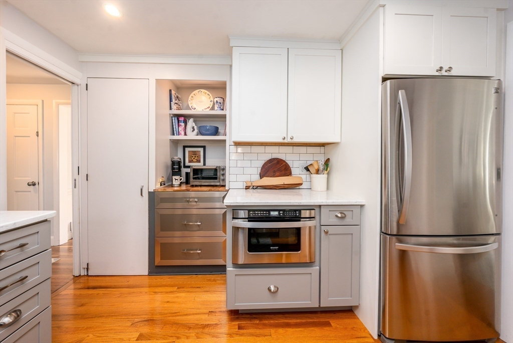 142 Chestnut Street Barnstable, MA 02601 - Photo 9 of 42 a kitchen with stainless steel appliances a refrigerator and a stove top oven