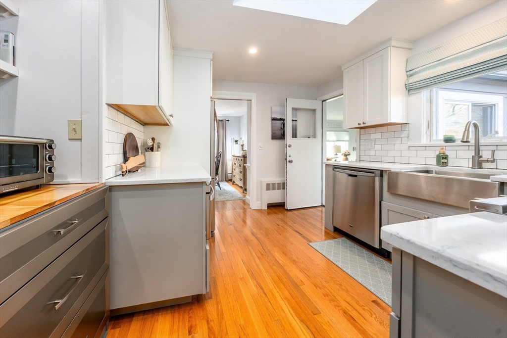 142 Chestnut Street Barnstable, MA 02601 - Photo 10 of 42 a kitchen with stainless steel appliances granite countertop a sink and cabinets