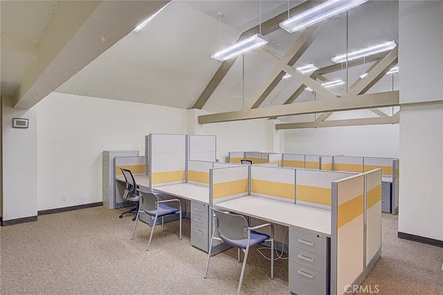 a view of a hallway with workspace and a window