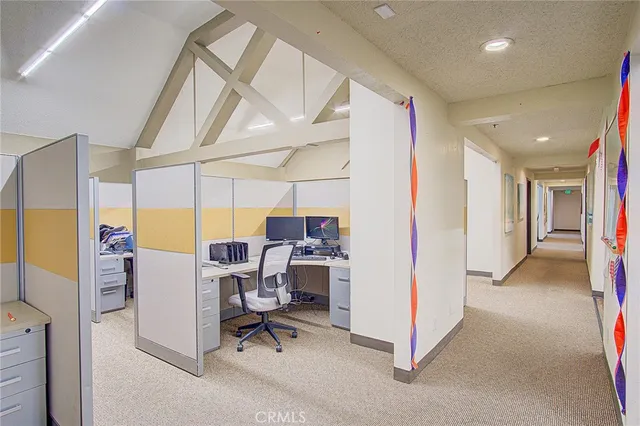 a view of a dining room with a table and chairs