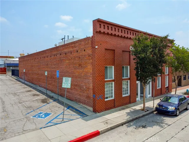 a front view of a building with parking space