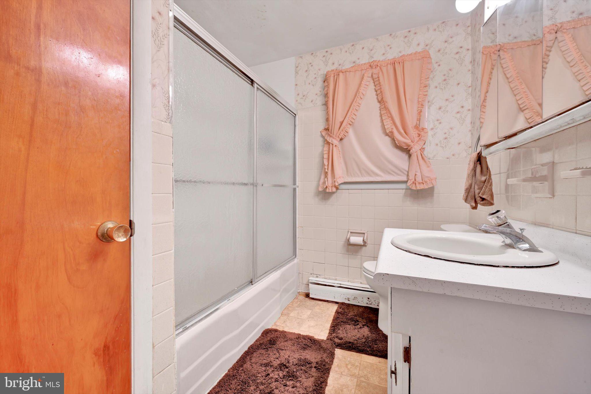 322 Morrison Road Reading, PA 19601 - Photo 16 of 29 a bathroom with a sink a toilet and shower curtain