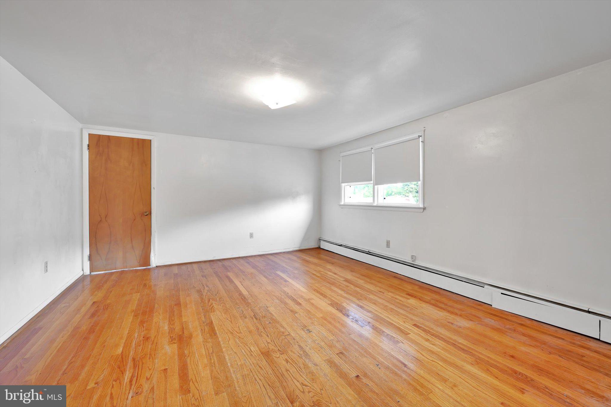 322 Morrison Road Reading, PA 19601 - Photo 17 of 29 an empty room with wooden floor and windows
