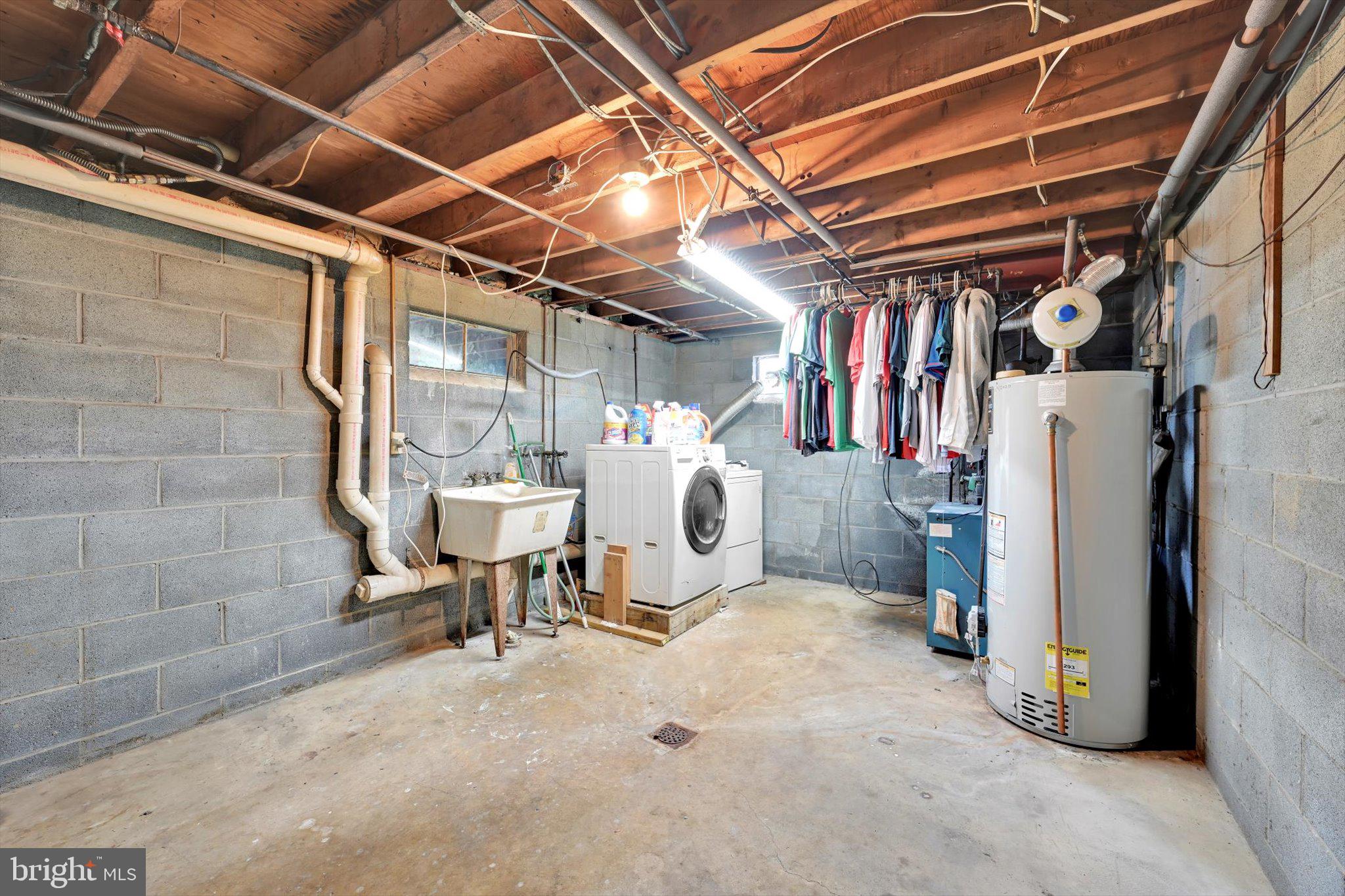 322 Morrison Road Reading, PA 19601 - Photo 25 of 29 a view of a storage room with water heater and racks