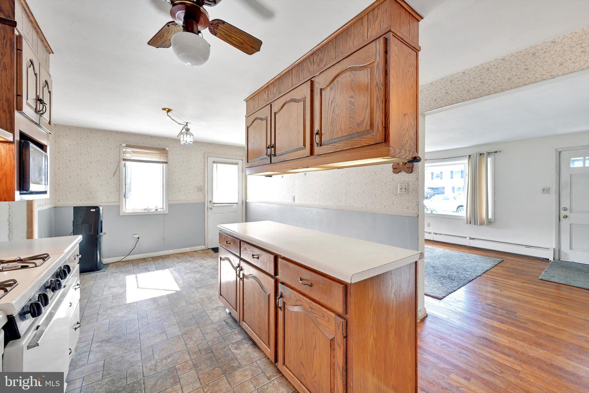 322 Morrison Road Reading, PA 19601 - Photo 8 of 29 a kitchen with stainless steel appliances granite countertop a refrigerator a stove and a wooden floors