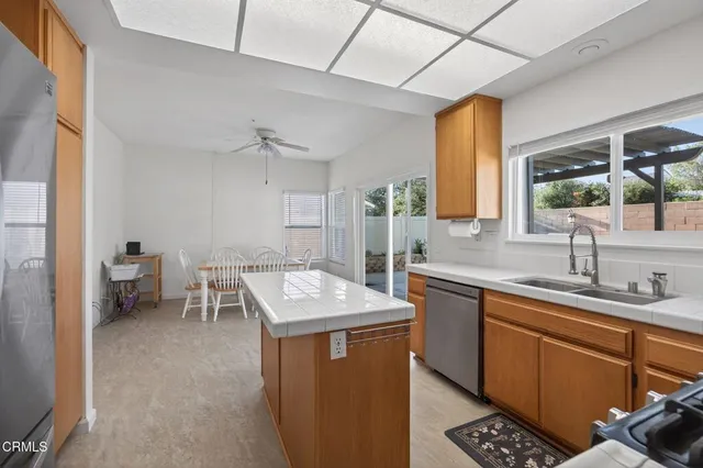 a room with sink cabinets and appliances