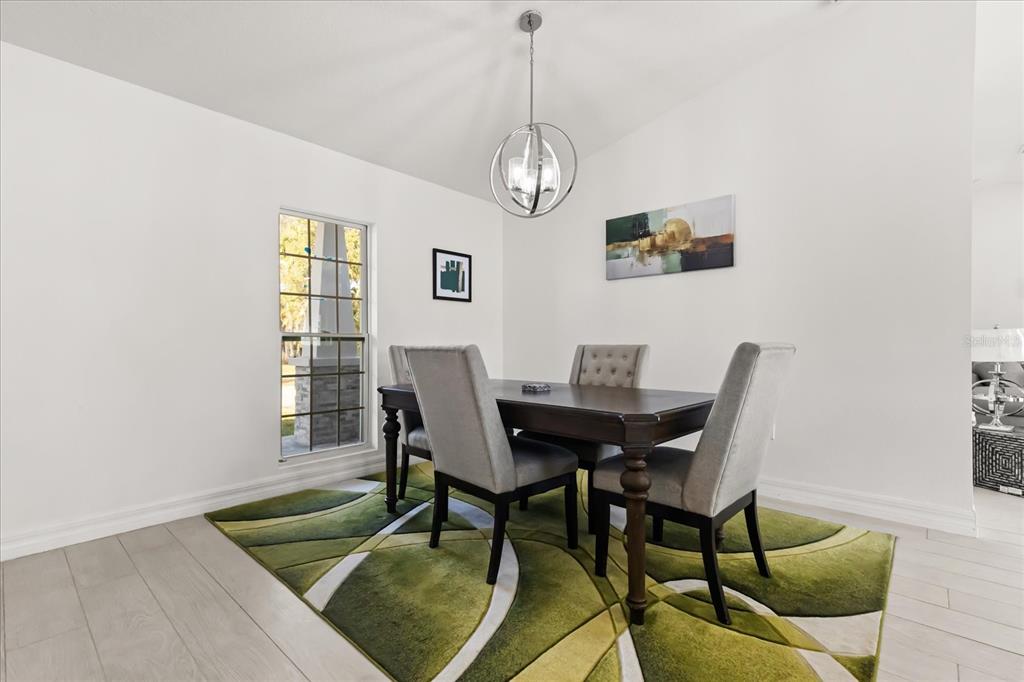 812 Chastain Road Seffner, FL 33584 - Photo 8 of 26 a view of a dining room with furniture and chandelier