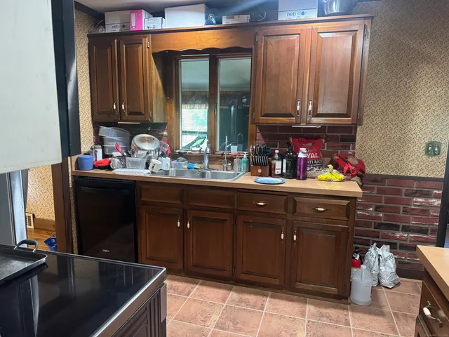 a kitchen with stainless steel appliances a sink stove and cabinets
