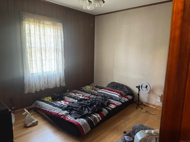 a bed sitting in a bedroom next to a window