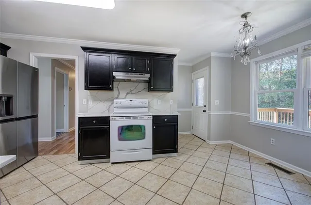 a kitchen with kitchen island granite countertop a stove and a refrigerator