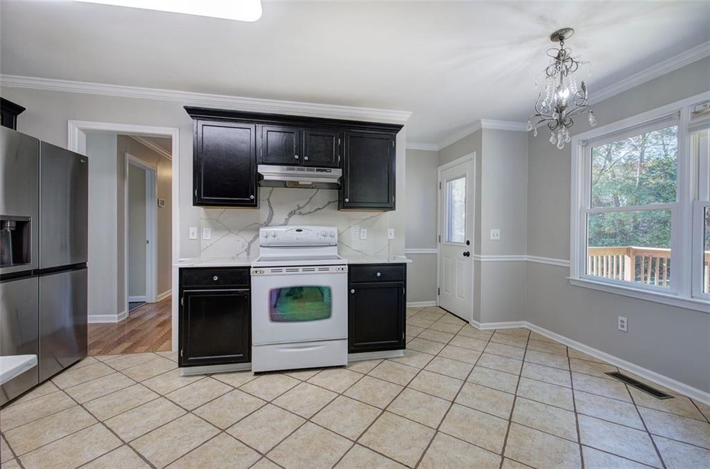 33 Engineer Lane Cartersville, GA 30120 - Photo 14 of 39 a kitchen with kitchen island granite countertop a stove and a refrigerator