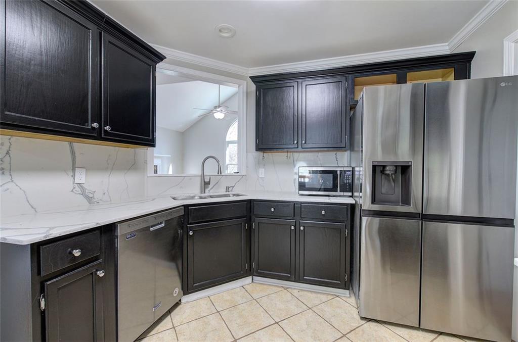 33 Engineer Lane Cartersville, GA 30120 - Photo 17 of 39 a kitchen with a sink a refrigerator and cabinets