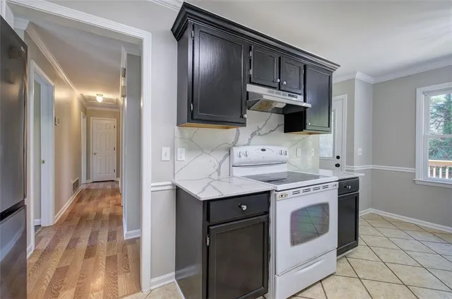 a kitchen with stainless steel appliances granite countertop a stove and a sink