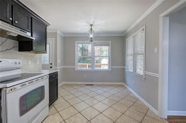 a kitchen with granite countertop a stove and a sink