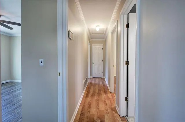 a view of a hallway with wooden floor