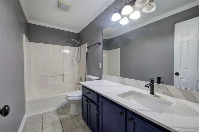 a bathroom with a sink a toilet a mirror a vanity and shower