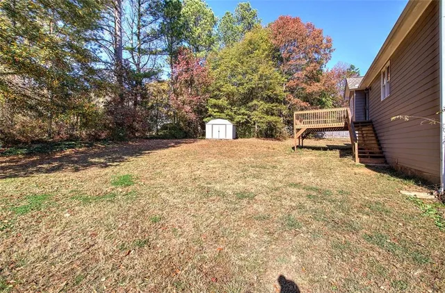 a view of a yard with a large tree