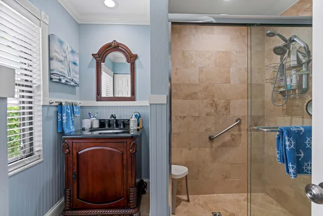 a bathroom with a granite countertop sink a toilet and a shower